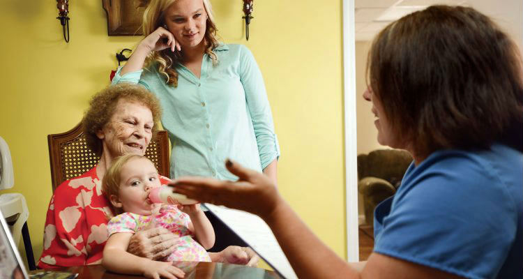 Hospice nurse with family