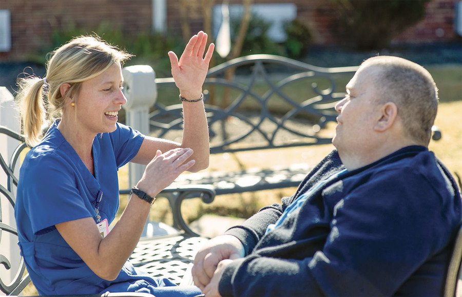 Nurse talking with Aaron in the garden