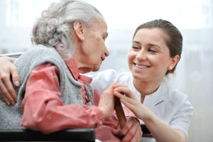 woman talking with elderly woman about caregivers FAQs