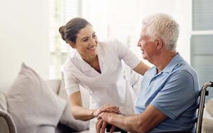 nurse smiles at patient while discussing hospice care for end-stage parkinsons disease