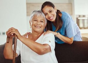 woman and nurse smiling while discussing hospice care and palliative care for stroke
