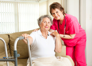 nurse and patient smile at camera while discussing hospice resources