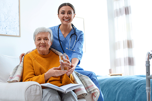 nurse and hospice patient smiling at camera