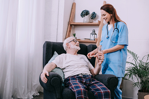 patient and nurse smile and discuss what hospice care is