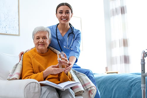 nurse smiles next to patient while discussing care to meet your needs and values