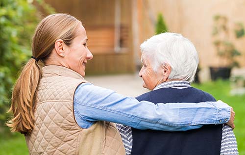 woman puts arm around patient while discussing the functional assessment staging tool for dementia