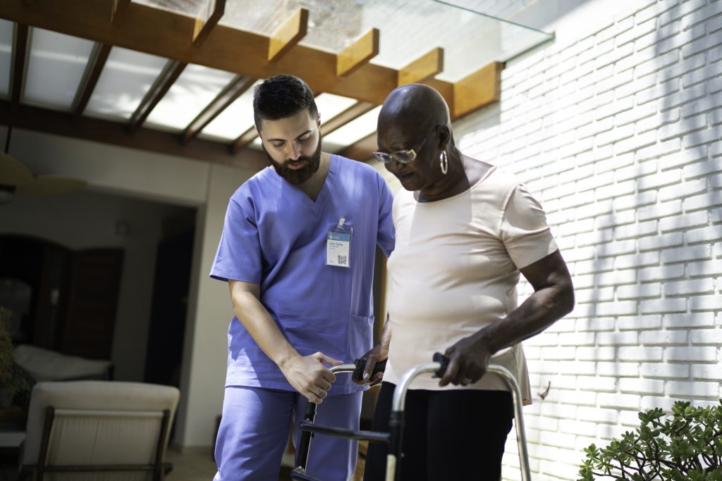 Male PT helps female patient with walking