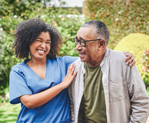 Female nurse laughing with older adult male